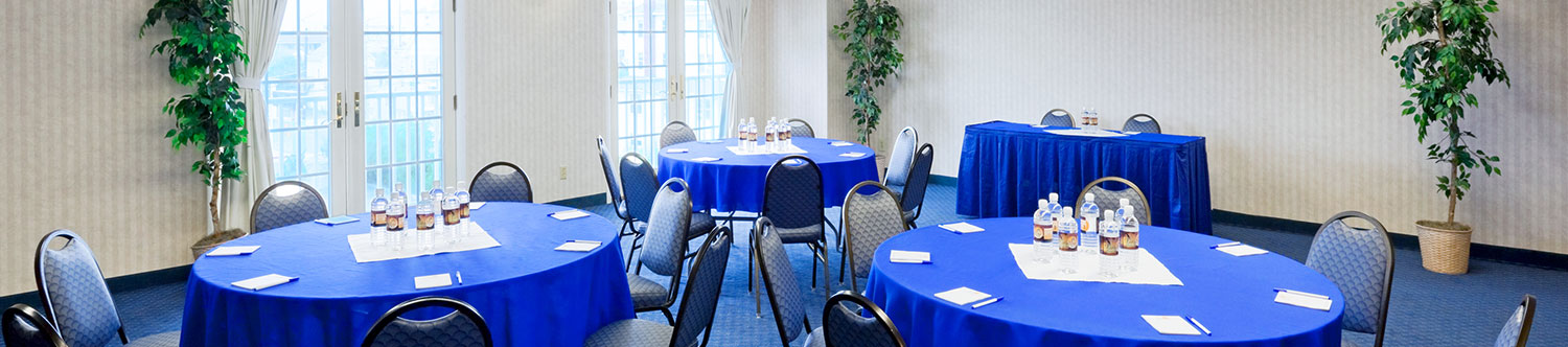 Several banquet tables in our meeting and banquet space