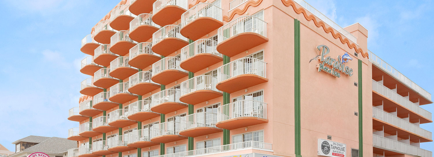 Exterior angled view of Paradise Plaza Inn showing many rooms with balconies